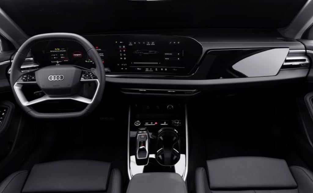 Painel frontal do novo Audi A5 2025, com volante esportivo multifuncional, dupla tela digital curva e console central premium.